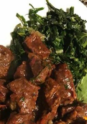 A picture of Wet fry liver served with saute kales.
