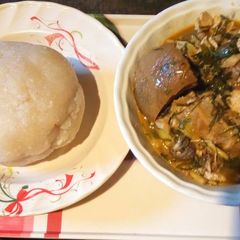 A picture of Ukazi soup with white garri.