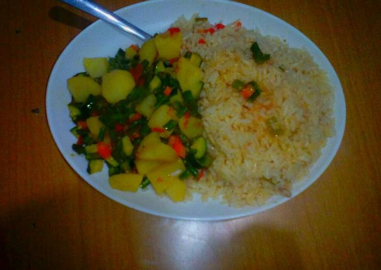 Buttered rice accompanied by mixed veges with potatoes