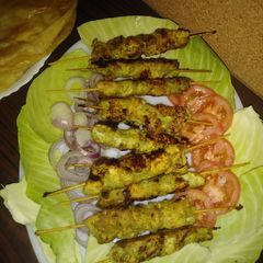 A picture of Chicken afghani boti/ puri paratha.