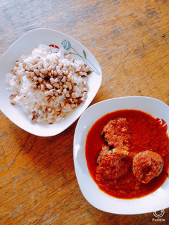 A picture of Rice and beans with fish stew.