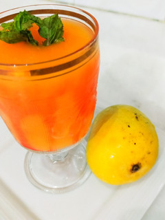 A picture of Mango juice with roohafzah.