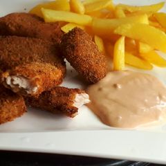A picture of Fish fingers served with French fries.