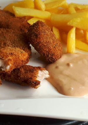 A picture of Fish fingers served with French fries.