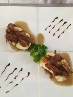 Una foto de Lomo de cerdo, con capa de mozzarella en salsa de cebolla.