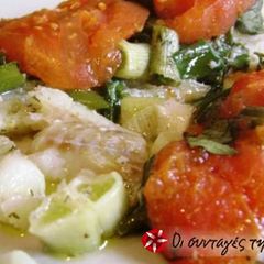 A picture of Fish in greaseproof paper with ouzo.