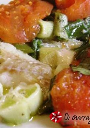 A picture of Fish in greaseproof paper with ouzo.