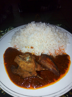 A picture of White rice and chicken stew.