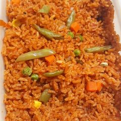 A picture of Jollof rice with vegetables.