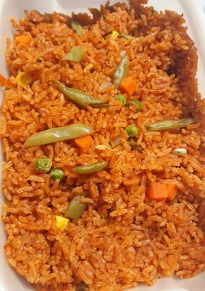 A picture of Jollof rice with vegetables.