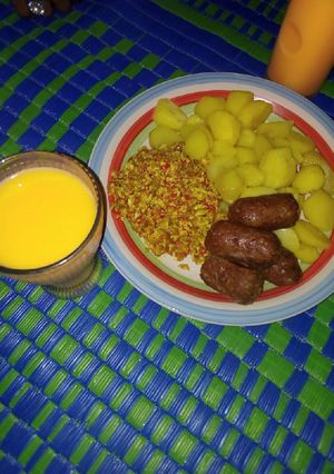A picture of Boiled potatoes served with egg sauce and meat bars &Shashkabash.