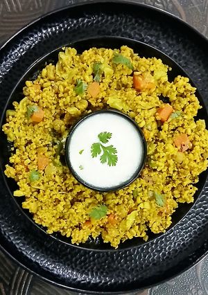 A picture of Foxtail Millet Khichdi with Moong Sprouts/Soya Chunks and mixed vegetables.