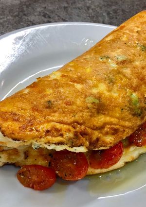 A picture of Cheddar, Broccoli and Red Chilli Soufflé Omelette, Garlic roasted Cherry Plum Tomatoes, Olive Oil.