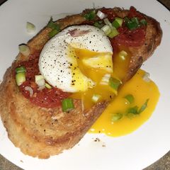 A picture of Tomato and poached egg garlic toast.