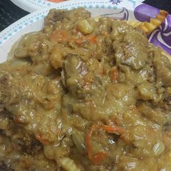 A picture of Smothered Chicken Liver over French Fries.