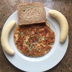 A picture of Breakfast cheese omelette # banana and bread.