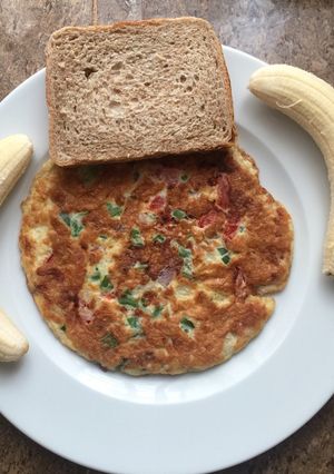 A picture of Breakfast cheese omelette # banana and bread.
