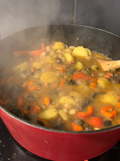 A picture of Spanish stew with chorizo and morcilla.