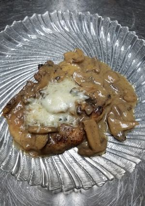 A picture of Mushroom marsala pork chops.