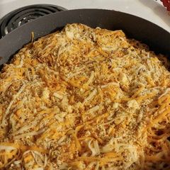 A picture of Spicy 🍅 and parmesan pasta with hamburger.