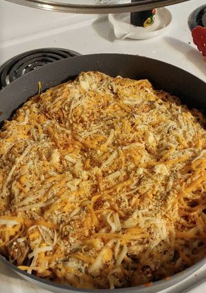A picture of Spicy 🍅 and parmesan pasta with hamburger.