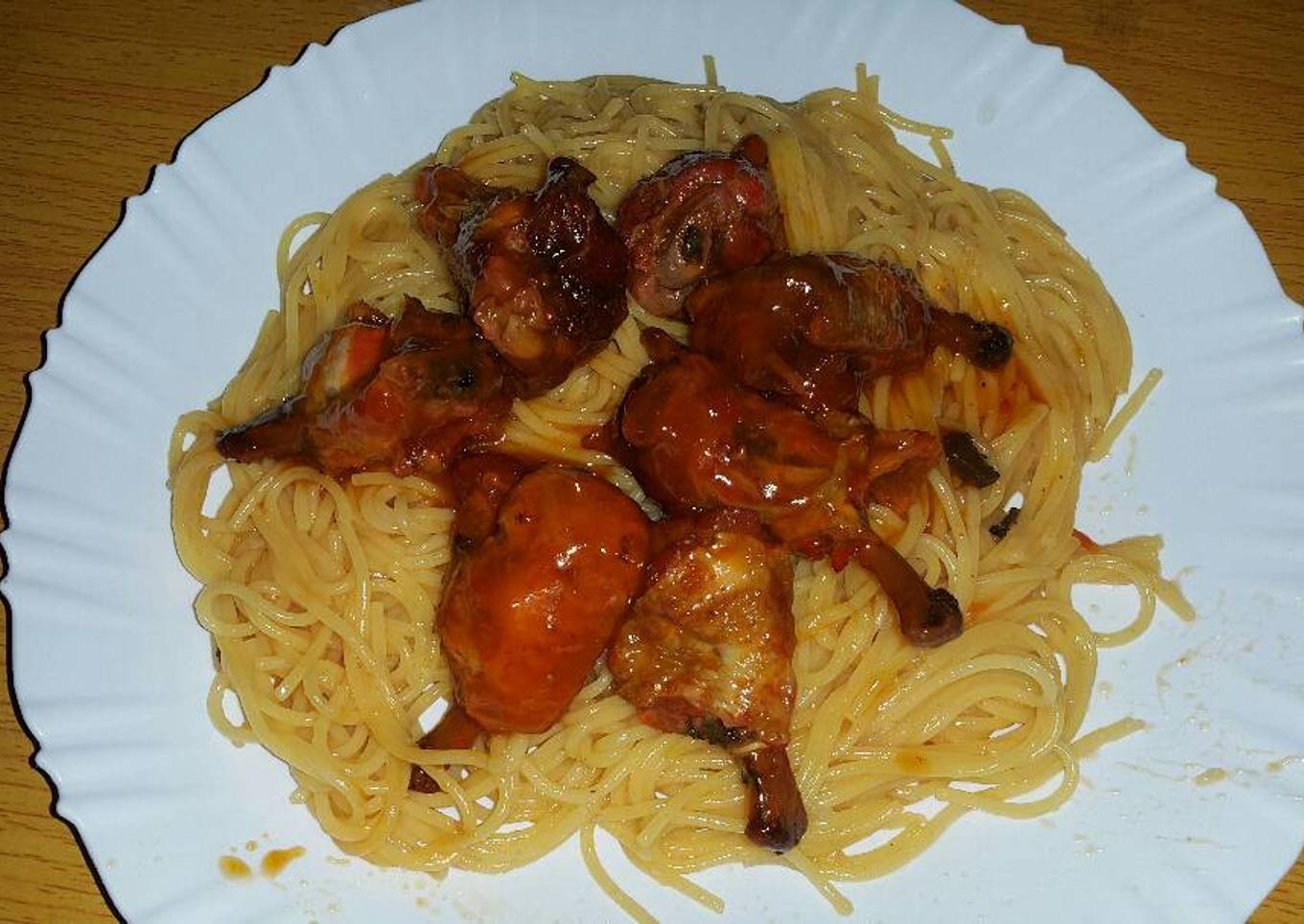 Chicken wings served with spaghetti