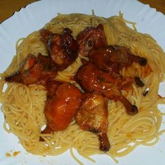 Chicken wings served with spaghetti A picture of Chicken wings served with spaghetti.