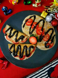 A picture of Strawberry pancakes with chocolate strawberry chilli sauce.