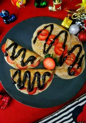 A picture of Strawberry pancakes with chocolate strawberry chilli sauce.