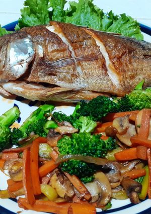A picture of Fried Mojarra with Sautéed Vegetables.
