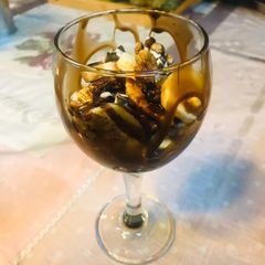 A picture of Goblet filled with Fluffy Pancakes and banana.