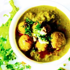 A picture of Dum aloo in Thai green curry.