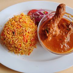 A picture of Indian Chicken Curry with Biryani.