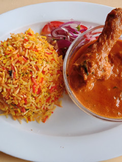 A picture of Indian Chicken Curry with Biryani.