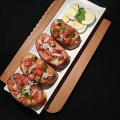 A picture of FRENCH GARLIC TOAST with TOMATO SALAD paired with BOILED EGGS..