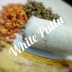 A picture of White Puttu with Green Moong Dhal and Egg accompanied Banana.