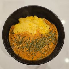 A picture of Chicken Paprikash on Polenta.
