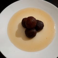 A picture of Caramelized milk and banana jamun.