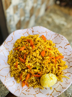 A picture of Macaroni jollof with carrots and egg.