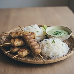 A picture of Aromatic Lamb and Vermicelli Skewers with Mint Dipping Sauce.