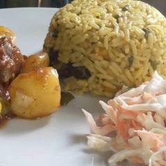 A picture of Jallof rice couslour with aresh souce.