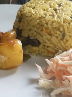 A picture of Jallof rice couslour with aresh souce.