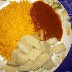 A picture of Yellow rice with yam and stew.