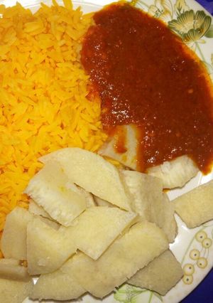 A picture of Yellow rice with yam and stew.