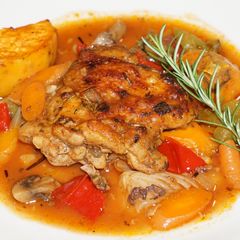 A picture of Chicken stew with sweet potato and fresh herbs.
