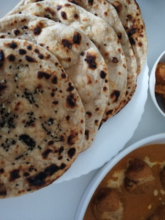 A picture of Garlic tandoori roti on tava.