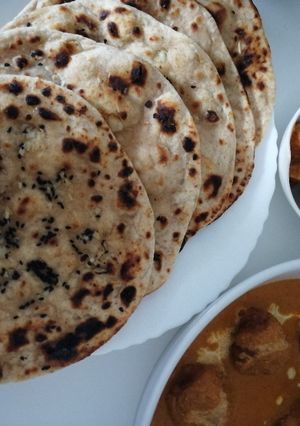 A picture of Garlic tandoori roti on tava.