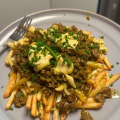 A picture of Curried Lamb Dirty Fries.
