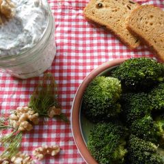 A picture of Roasted broccoli with a side order of greek yogurt dip.