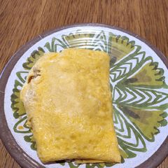 A picture of Fried Rice covered with Egg.